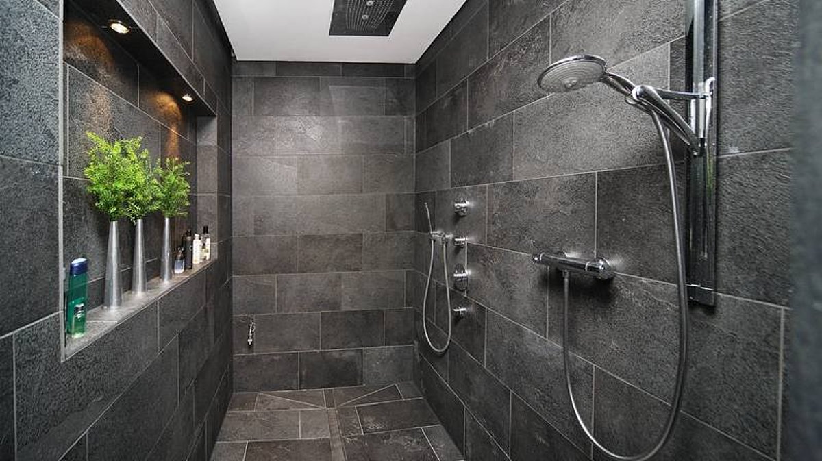 Eine Dusche mit großen Steinplatten.